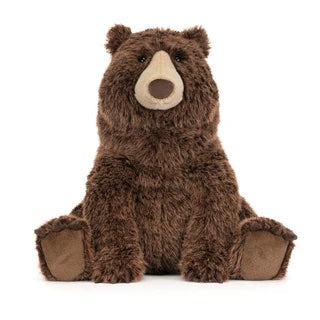 Myk JELLYCAT Bizzlestomp bjørn som ligger, laget av myk pels og har store øyne, perfekt som barneleke.